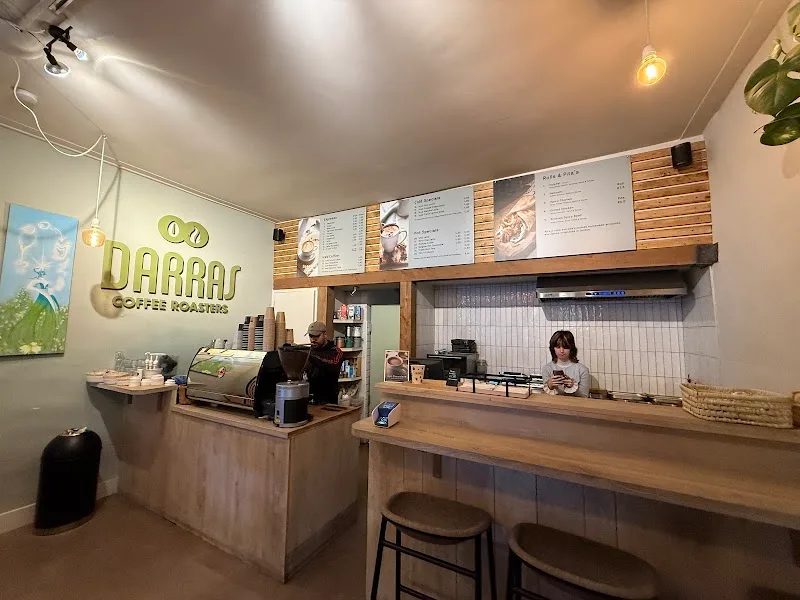 modern coffee shop interior with wooden counters and menu boards displayed above., darras coffee roasters utrecht, utrecht