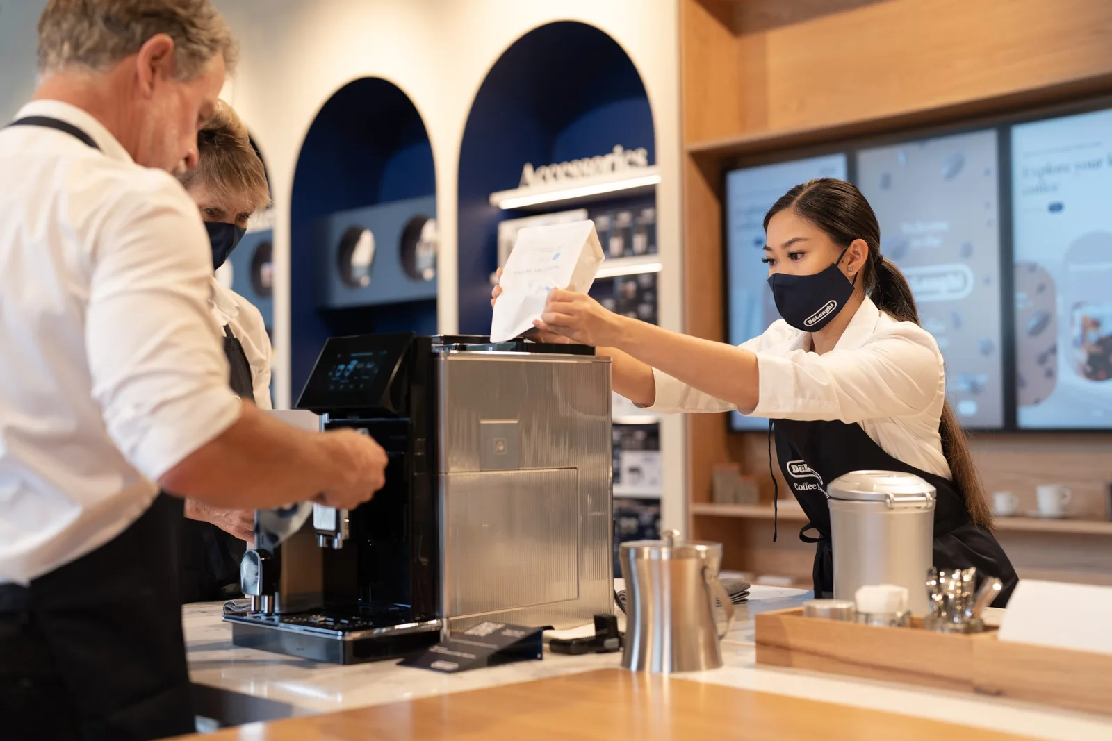 coffee shop barista serving customers at counter with espresso machine., de'longhi coffee lounge, zetland