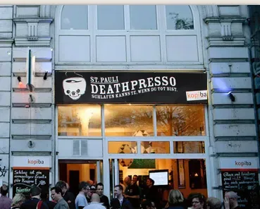 st. pauli death presso storefront with illuminated windows and gathered customers outside., death presso, hamburg