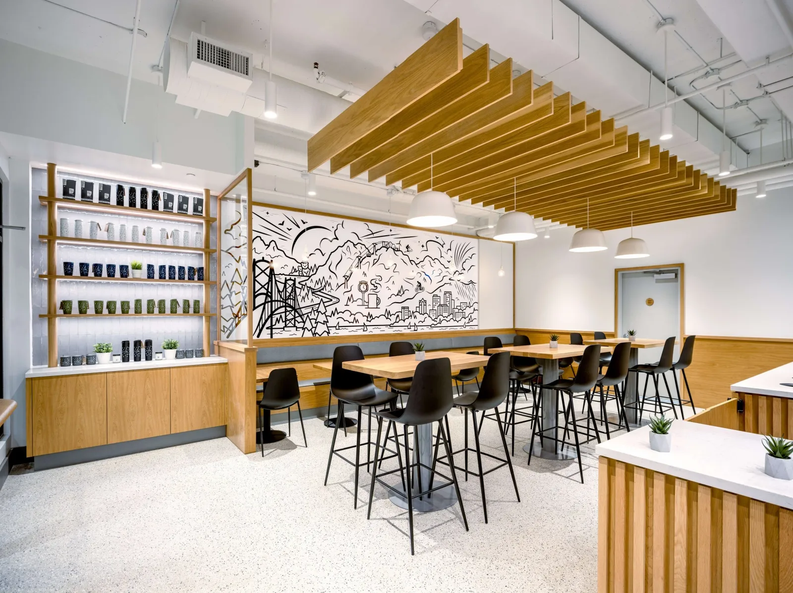 modern café interior with wooden shelving, bar seating, and urban mural artwork., delany's coffee house, north vancouver