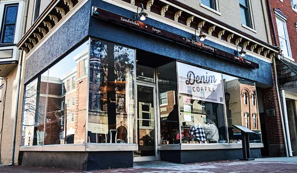 denim coffee storefront with large windows and black framing on street level., denim coffee, carlisle