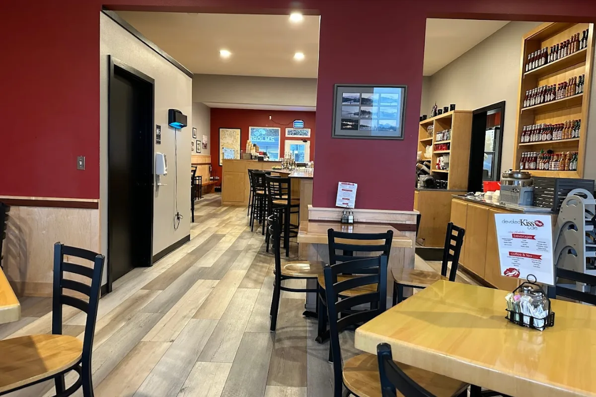 modern café interior with purple walls, wooden tables, and shelved products., devoted kiss cafe, gig harbor