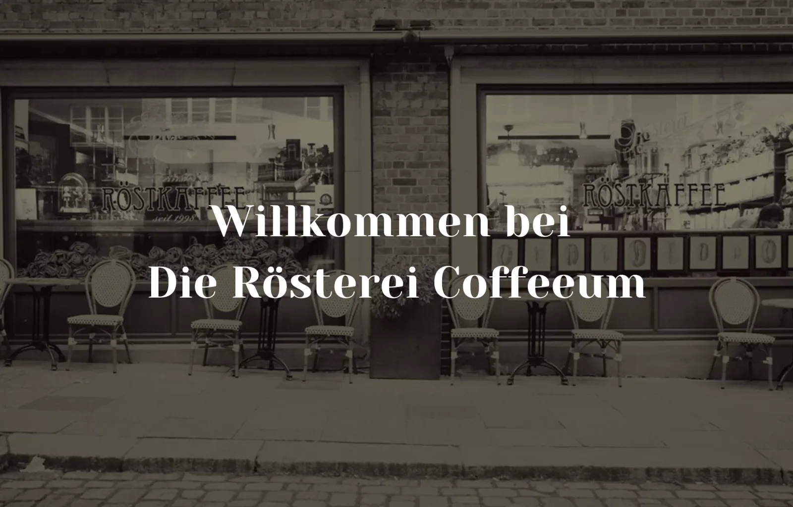 historic coffee roastery storefront with large windows and outdoor seating chairs., die rösterei coffeum gmbh & co kg, hambur