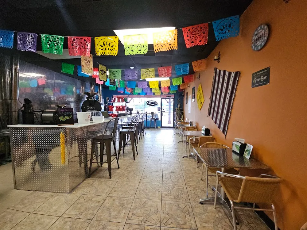 colorful mexican restaurant interior with counter seating and decorative papel picado banners., d.o.d. coffee roastery, clear