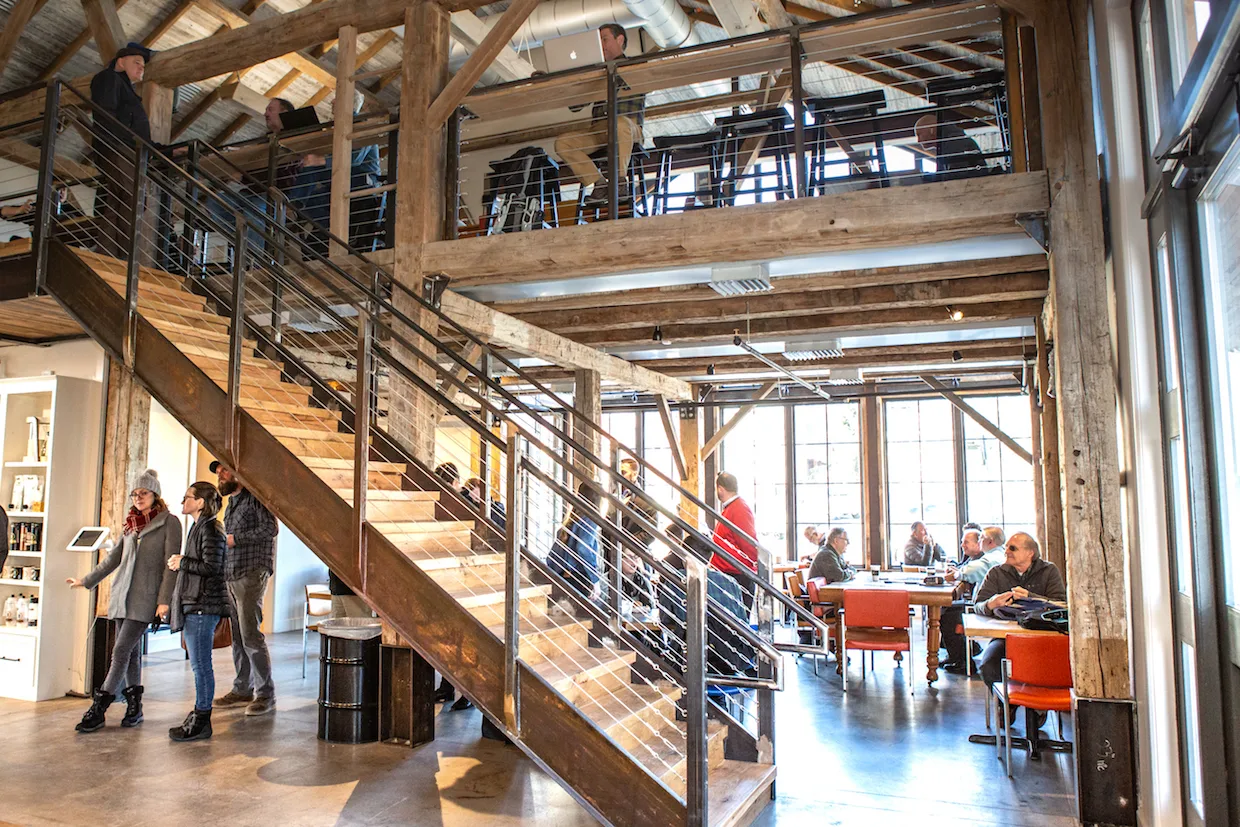 modern industrial loft space with wooden stairs, exposed beams, and multiple levels of occupancy., doubleshot coffee co, tuls