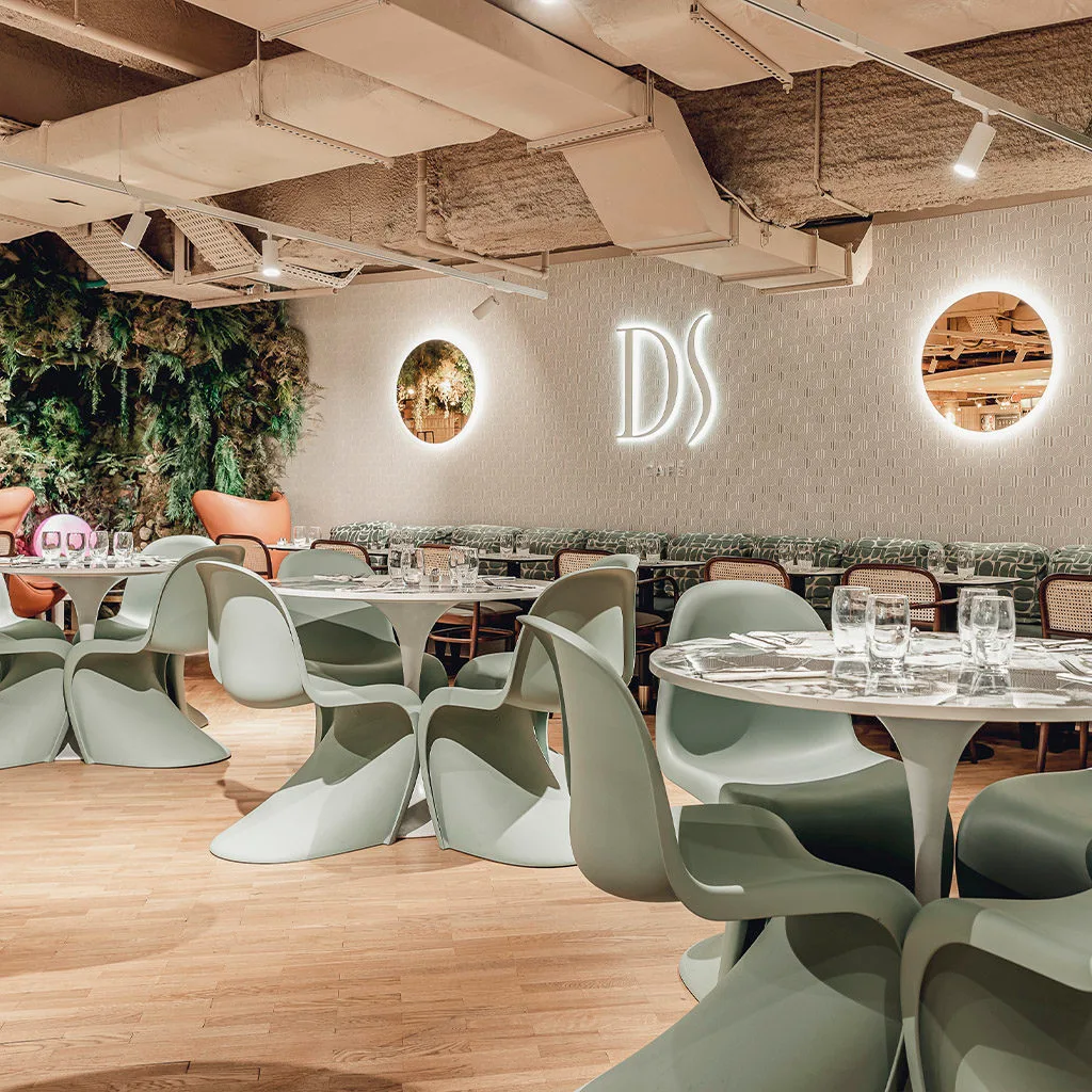 modern restaurant interior with sculptural chairs, neon signage, and living plant wall., ds café, paris
