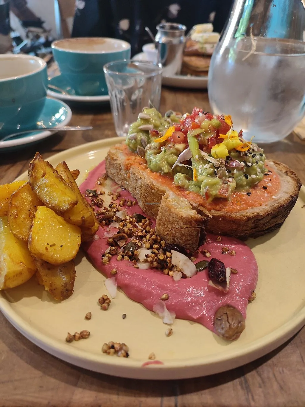 gourmet plated dish with toasted bread, guacamole, beet puree, roasted potatoes, and microgreens., eatmytrip malasaña brunch 
