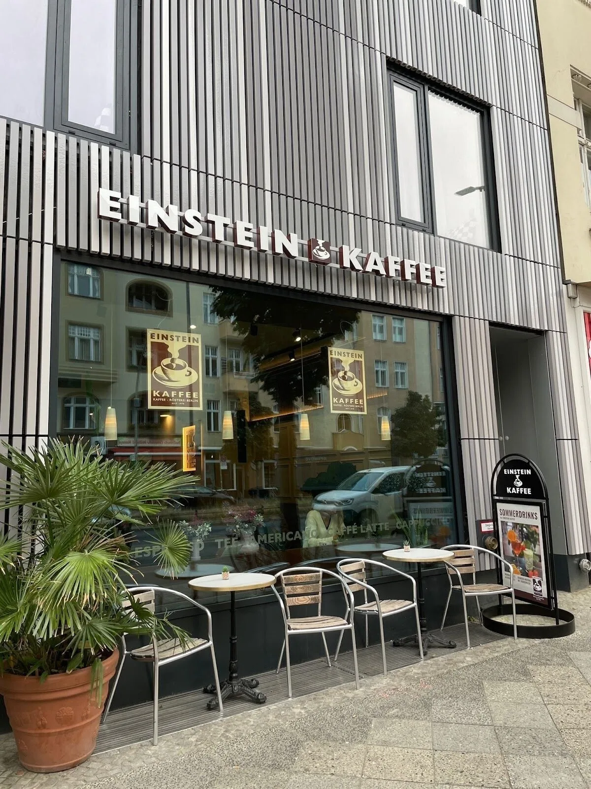 einstein kaffee café storefront with outdoor seating and potted plants., einstein kaffee - charlottenburg - kantstraße - berl