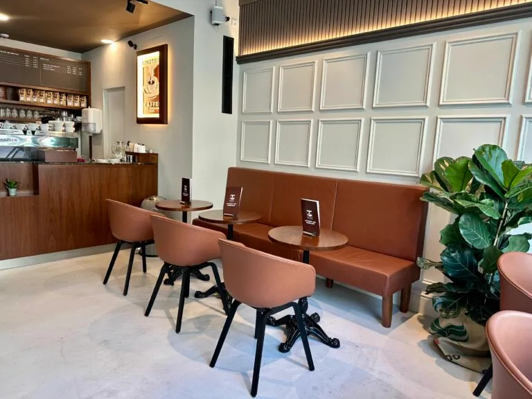 modern café interior with terracotta seating, wooden counter, and potted plants., einstein kaffee - charlottenburg - kantstra