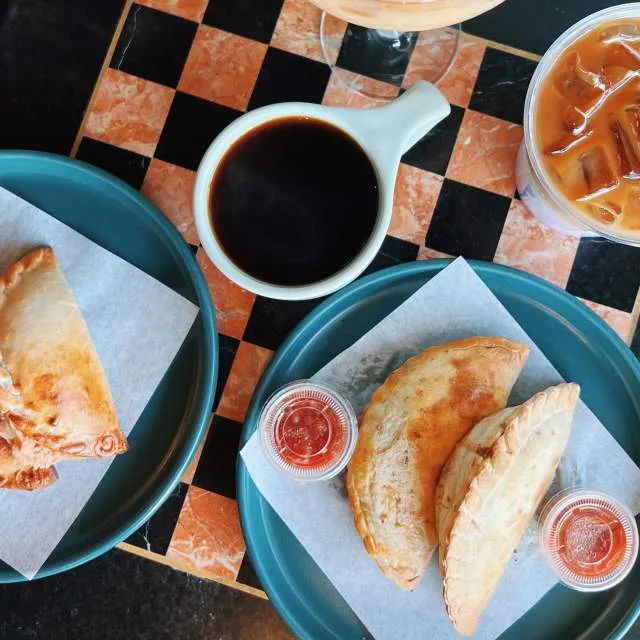 breakfast spread with pastries, coffee, and condiments on checkered tablecloth., el porton coffee, dallas