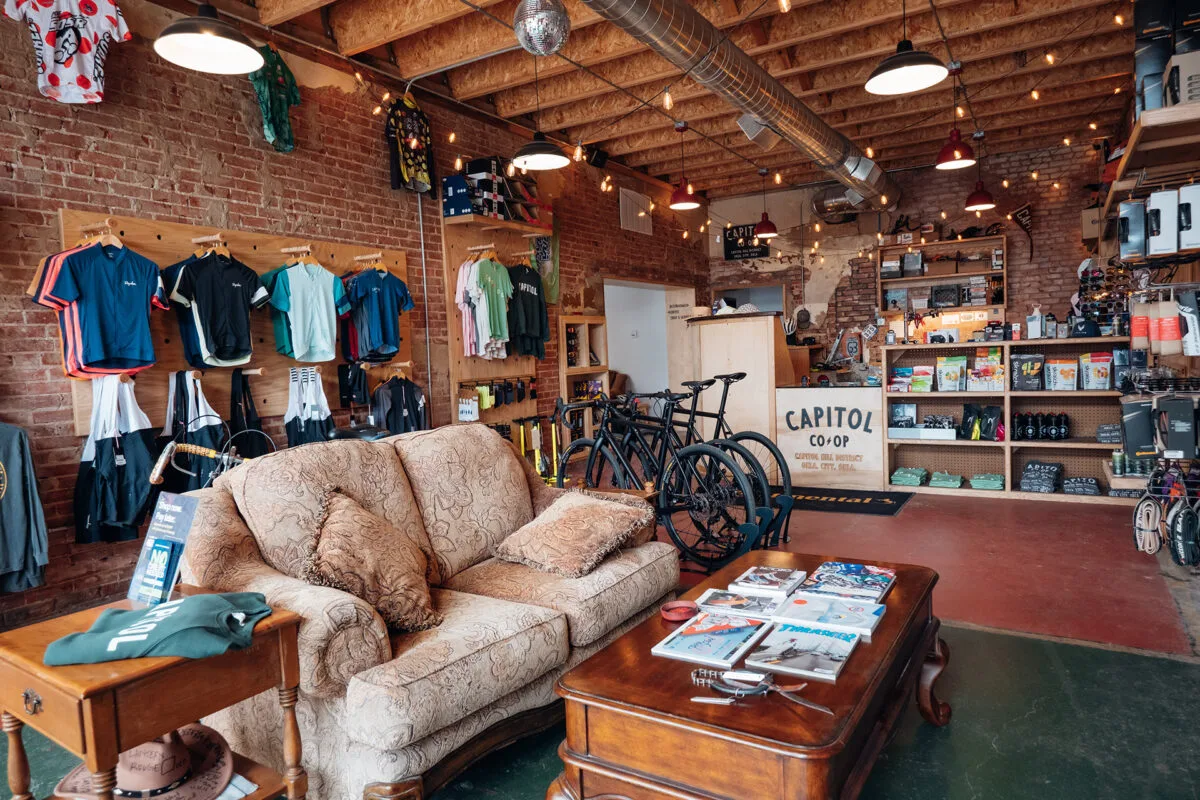 bicycle shop interior with couch, retail clothing displays, and wooden furniture., elemental coffee roasters llc, oklahoma