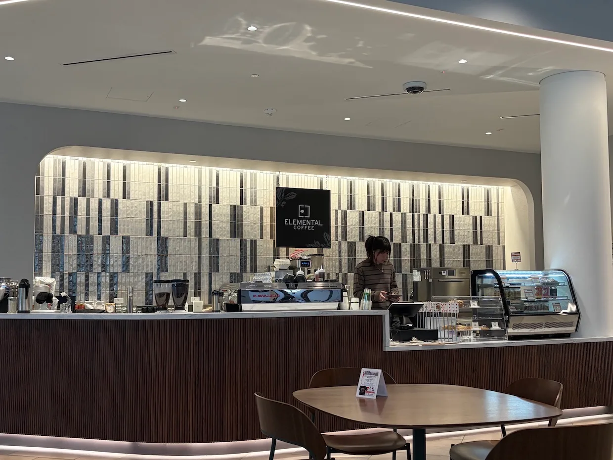 modern coffee shop interior with counter, barista, display case, and seating area., elemental coffee roasters llc, oklahoma