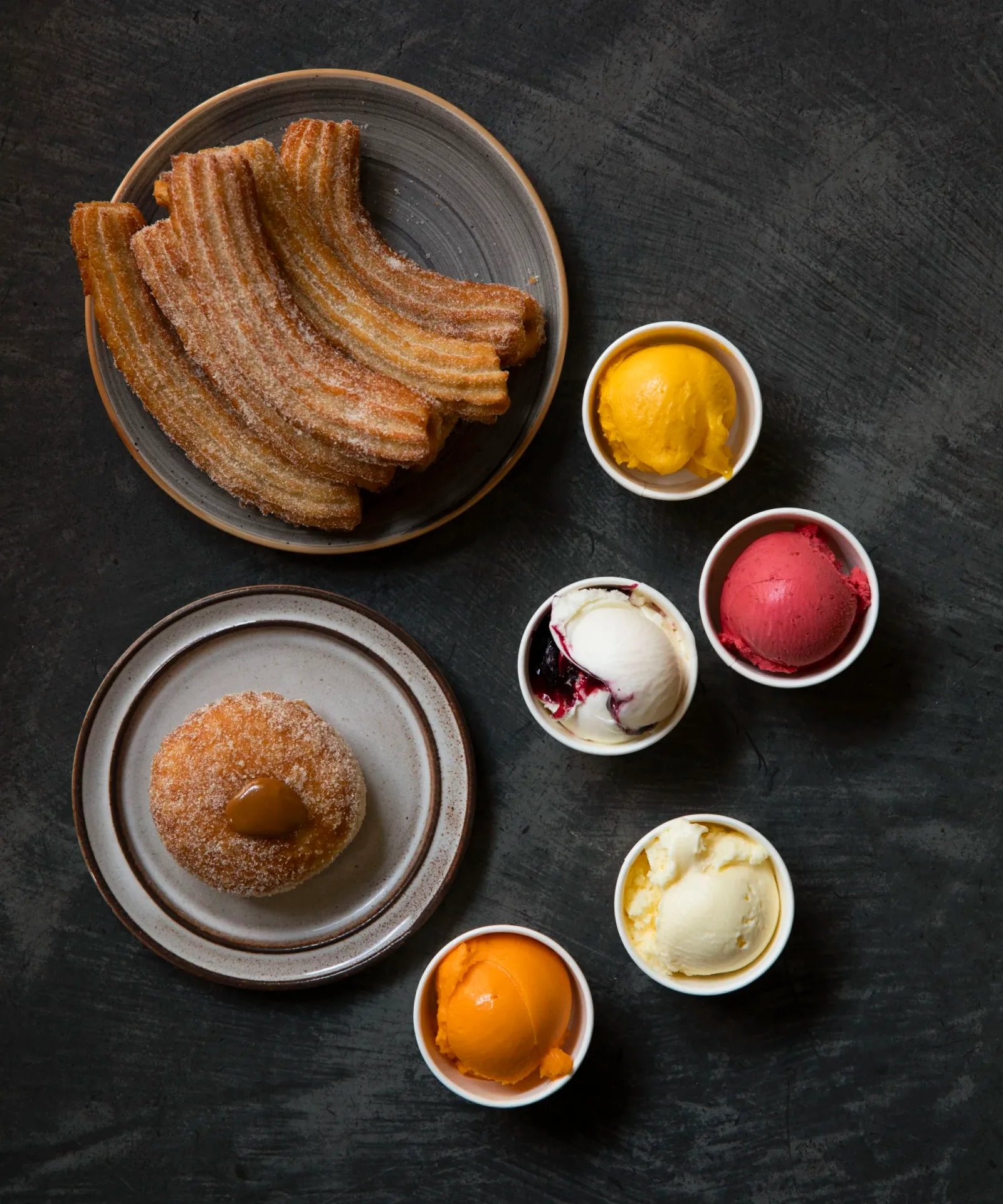 churros with cinnamon sugar and assorted ice cream flavors on dark surface., elis copenhagen, copenhagen