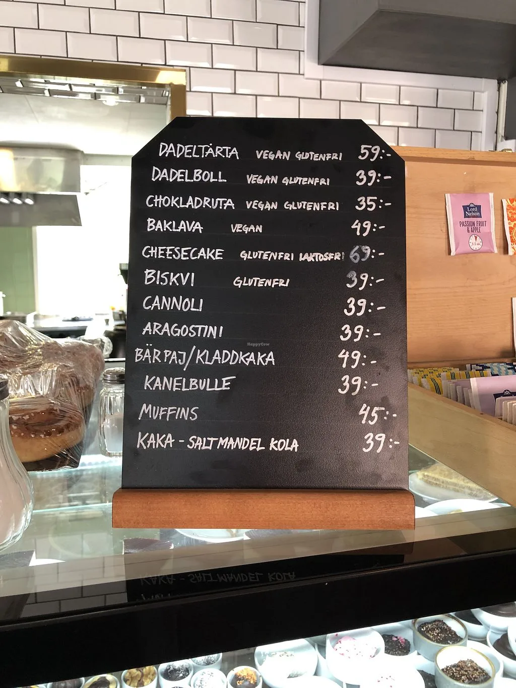black menu board displaying swedish pastries and desserts with prices in kronor., en deli haga, gothenburg