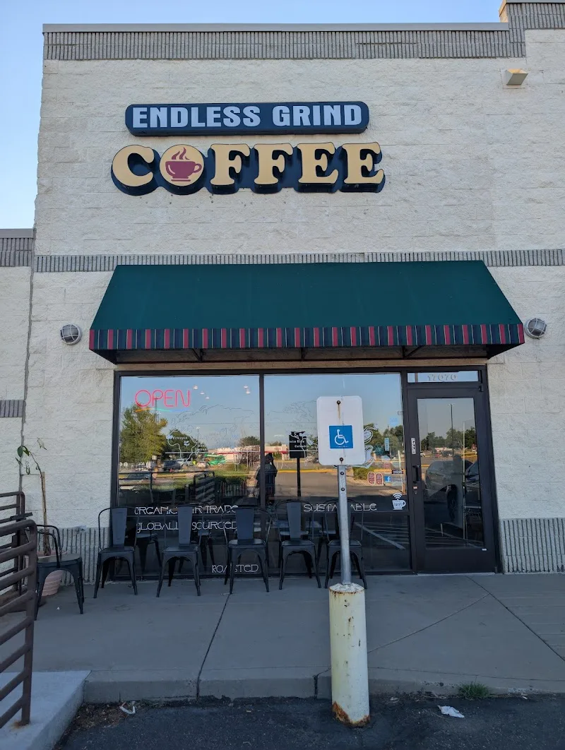 endless grind coffee storefront with teal awning and outdoor seating area., endless grind coffee, aurora
