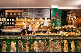 cozy café counter decorated with festive garland and holiday ornaments., ewig freunde, berlin