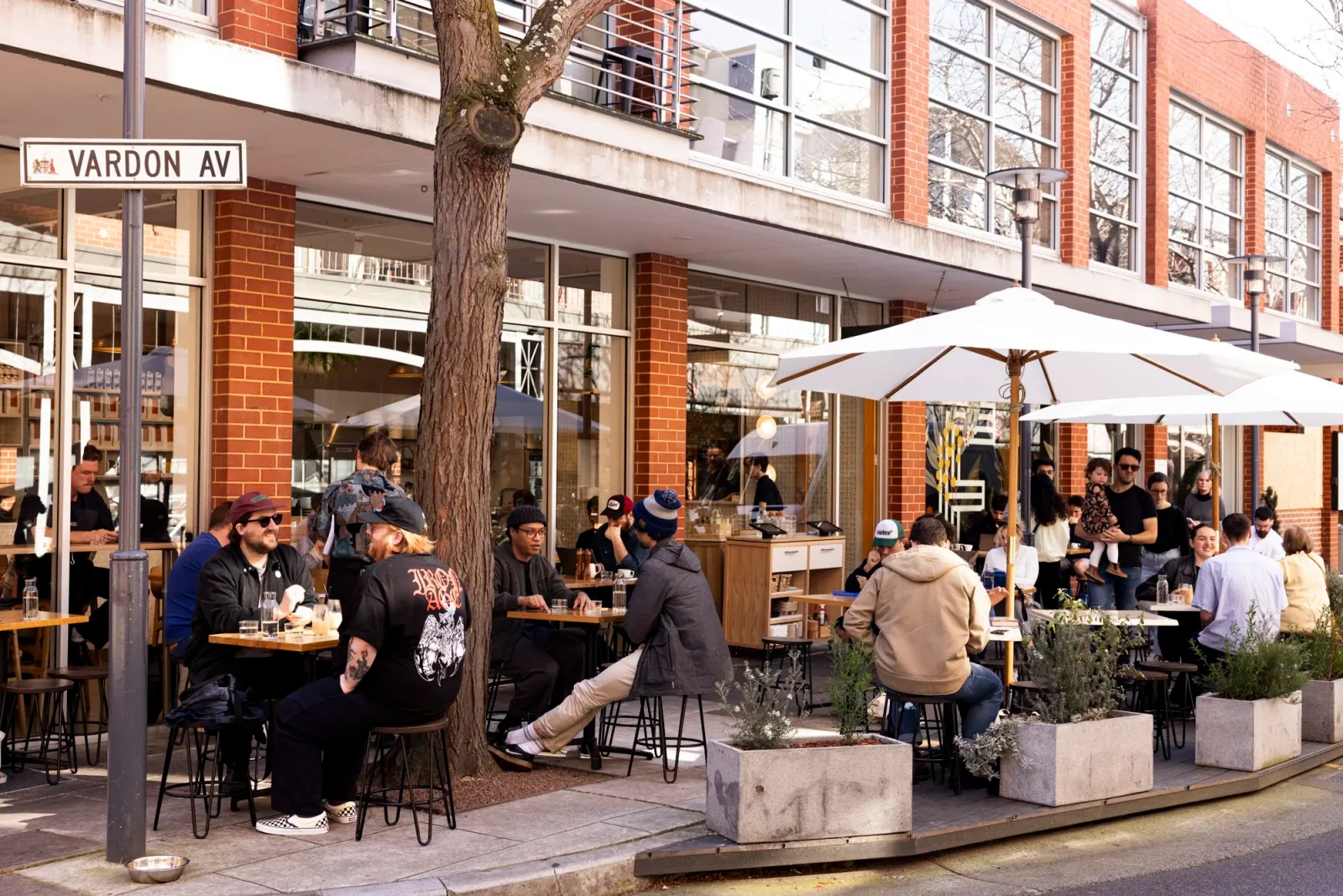 outdoor café on vardon avenue with diners under white umbrellas enjoying drinks., exchange coffee, adelaide