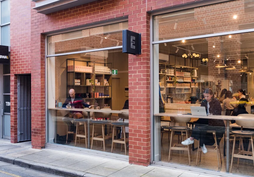 modern café with exposed brick, wooden counter, and customers seated at tables., exchange coffee, adelaide