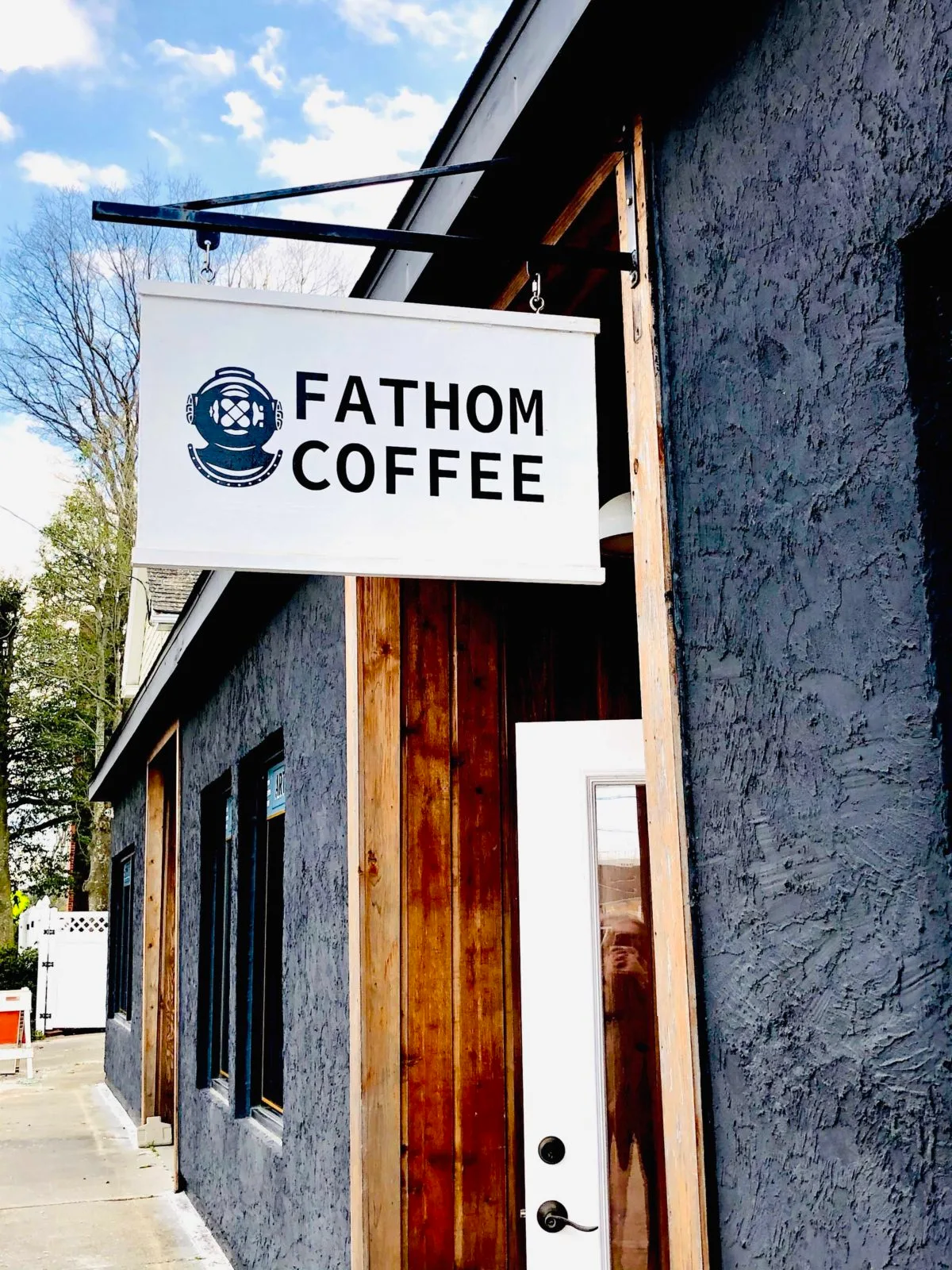 fathom coffee storefront with vintage diving helmet logo on weathered building exterior., fathom coffee, virginia beach