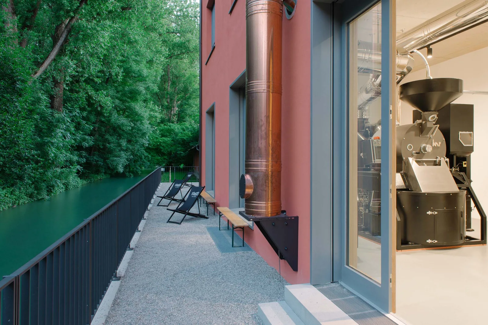 modern coffee roastery with industrial roaster visible through glass doors., fausto kaffeerösterei gmbh, munich