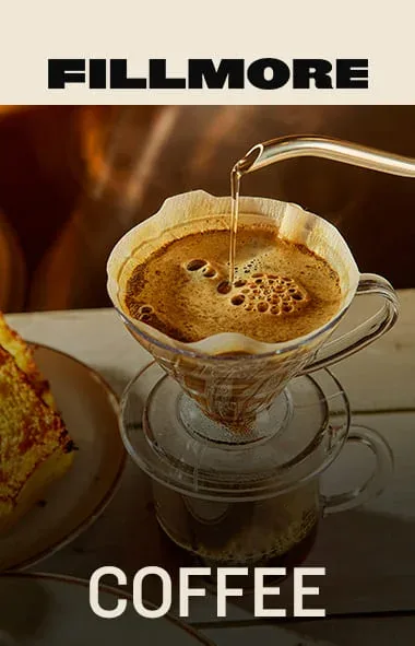 coffee pouring into filter cone over cup with pastry visible beside., fillmore ipiranga, são paulo