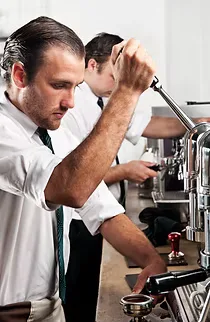 man in white shirt adjusting motorcycle engine component with wrench., fitzco coffee roasters, new york city