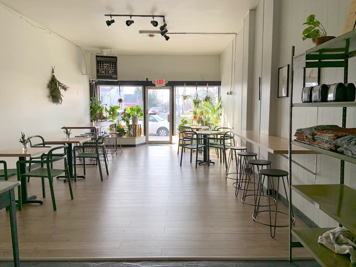 modern plant-filled cafe with green accents, wooden floors, and natural light., florin coffee, columbus
