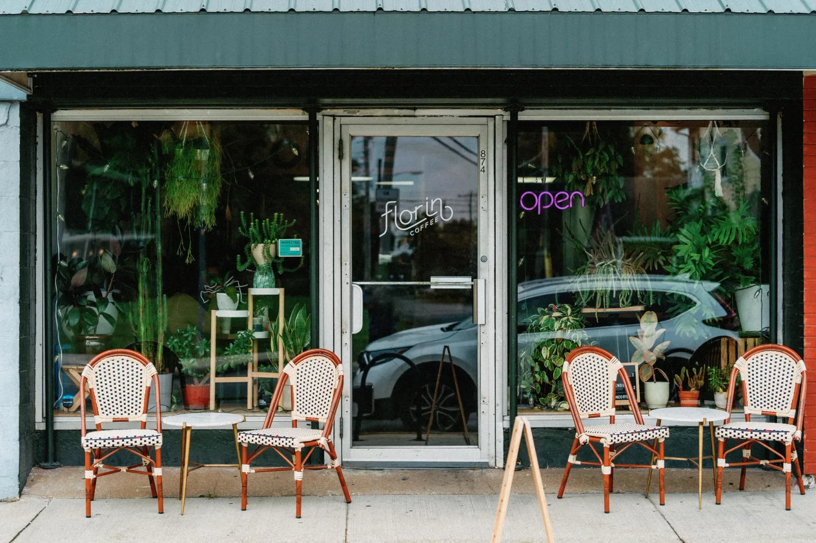 florib coffee shop storefront with plants, seating, and open sign displayed., florin coffee, columbus