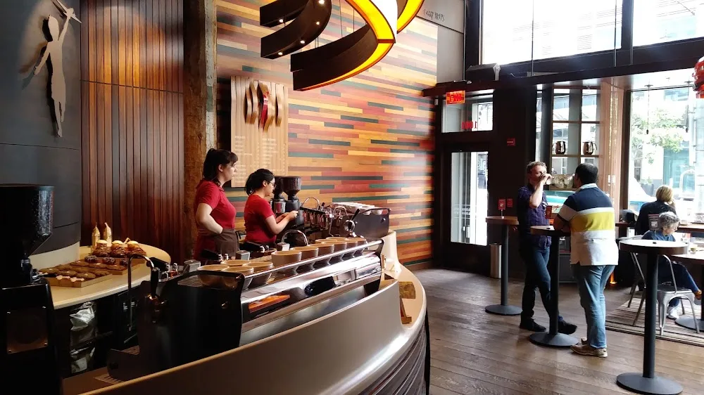 modern coffee shop interior with baristas at counter, colorful wall art, customers browsing., futurebean, seattle