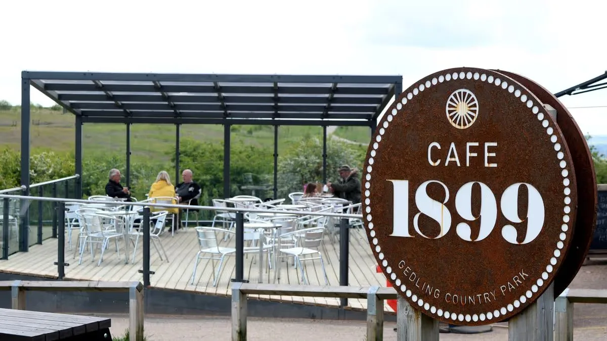 cafe 1899 sign with outdoor seating area and countryside views visible., gedling country park, arnold