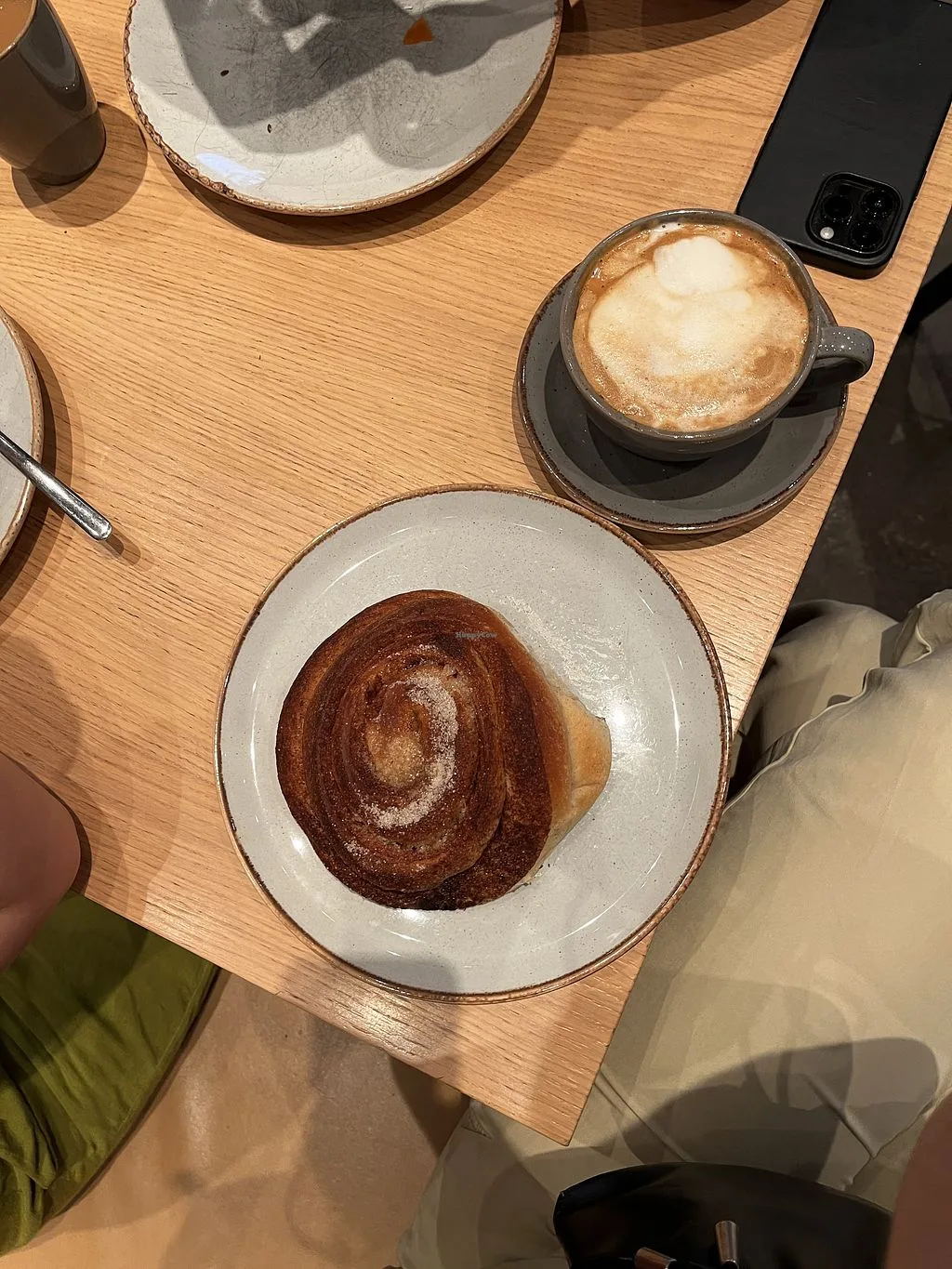 chocolate pastry with cinnamon sugar and cappuccino on wooden table., good bread floyen, bergen