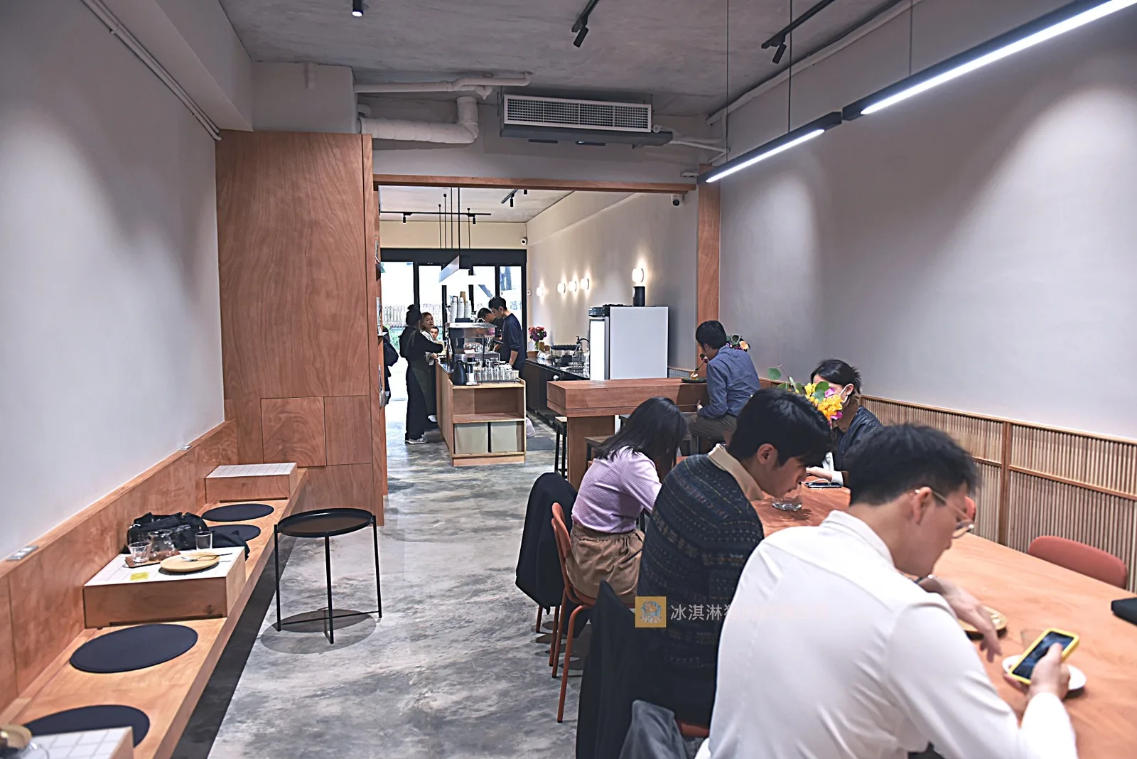 modern café interior with wooden counter seating and customers at tables., goodman roaster 華山店, taipei