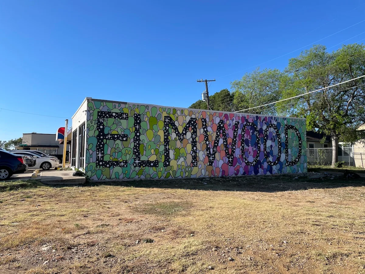 colorful mural with "leimao" text on building wall, clear blue sky., graph coffee, dallas