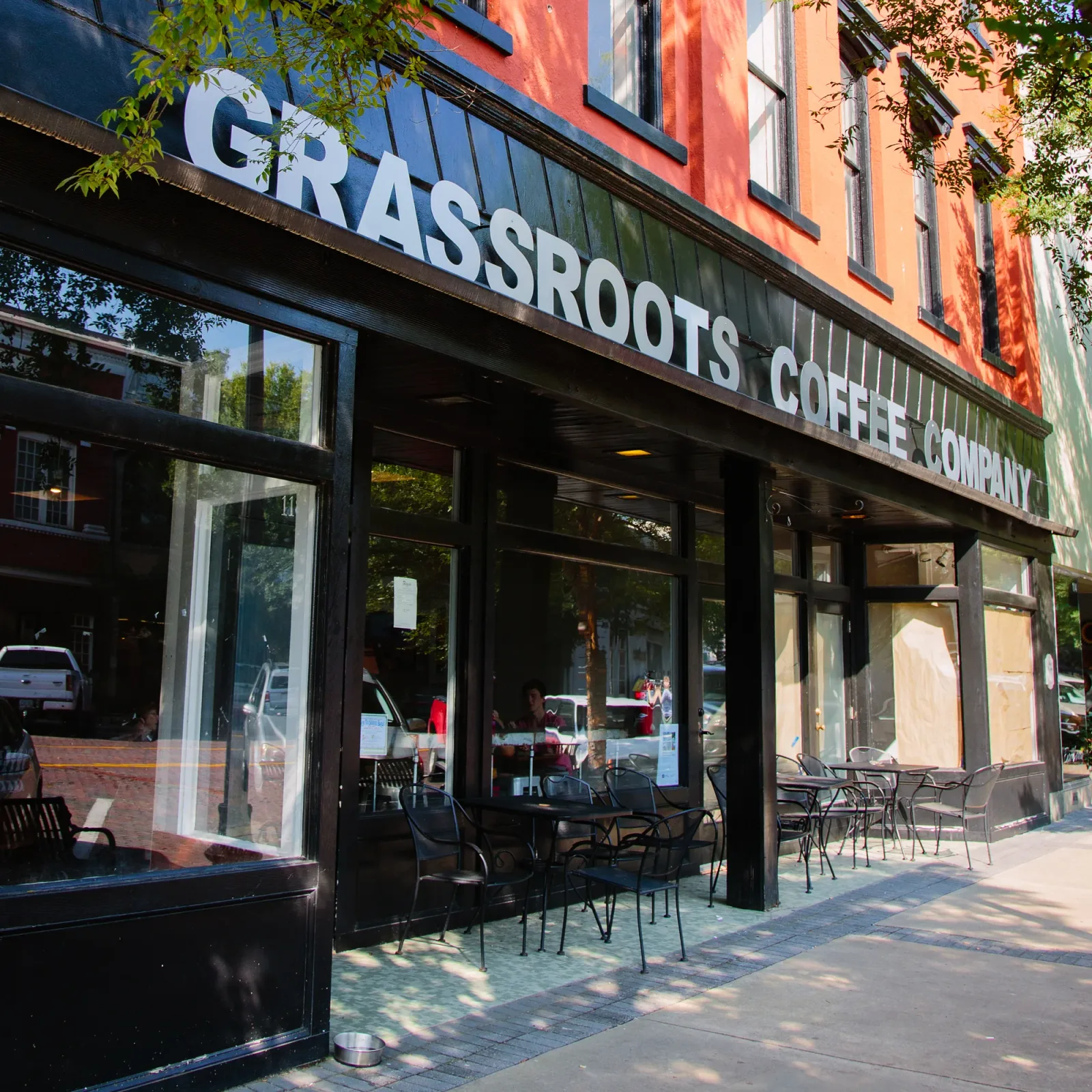 grassroots coffee company storefront with outdoor seating on sunny urban street., grassroots coffee, georgia