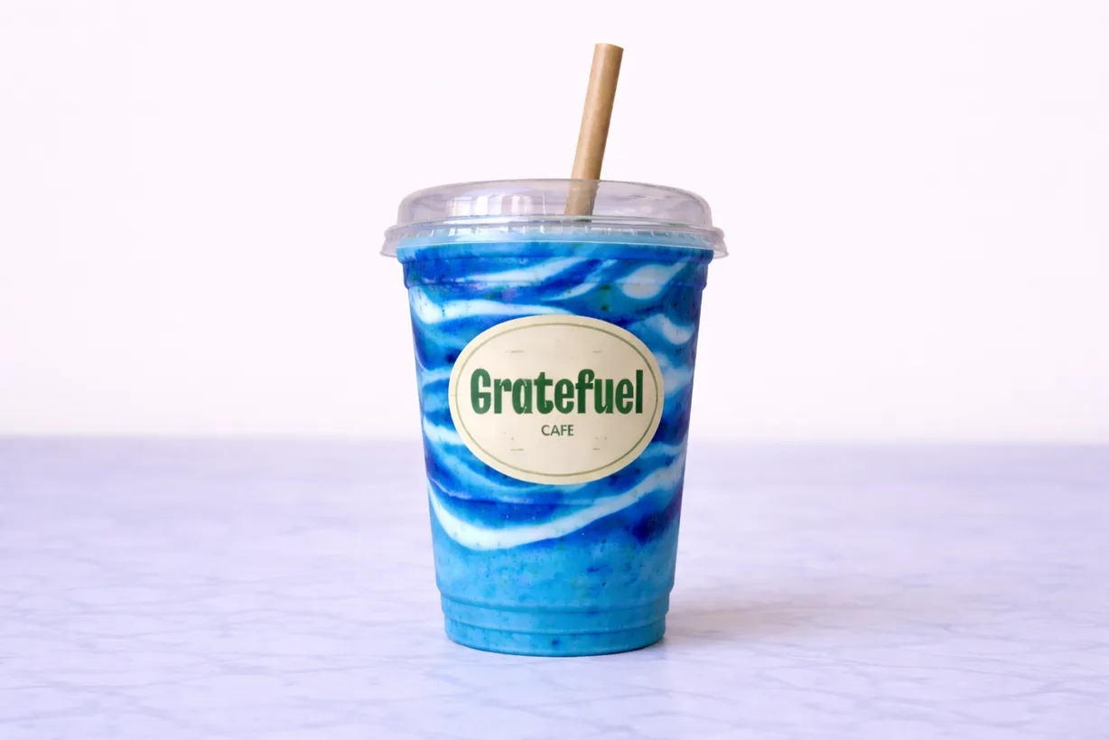 blue iced beverage in plastic cup with "gratefuel cafe" label and bamboo straw., gratefuel cafe, miami