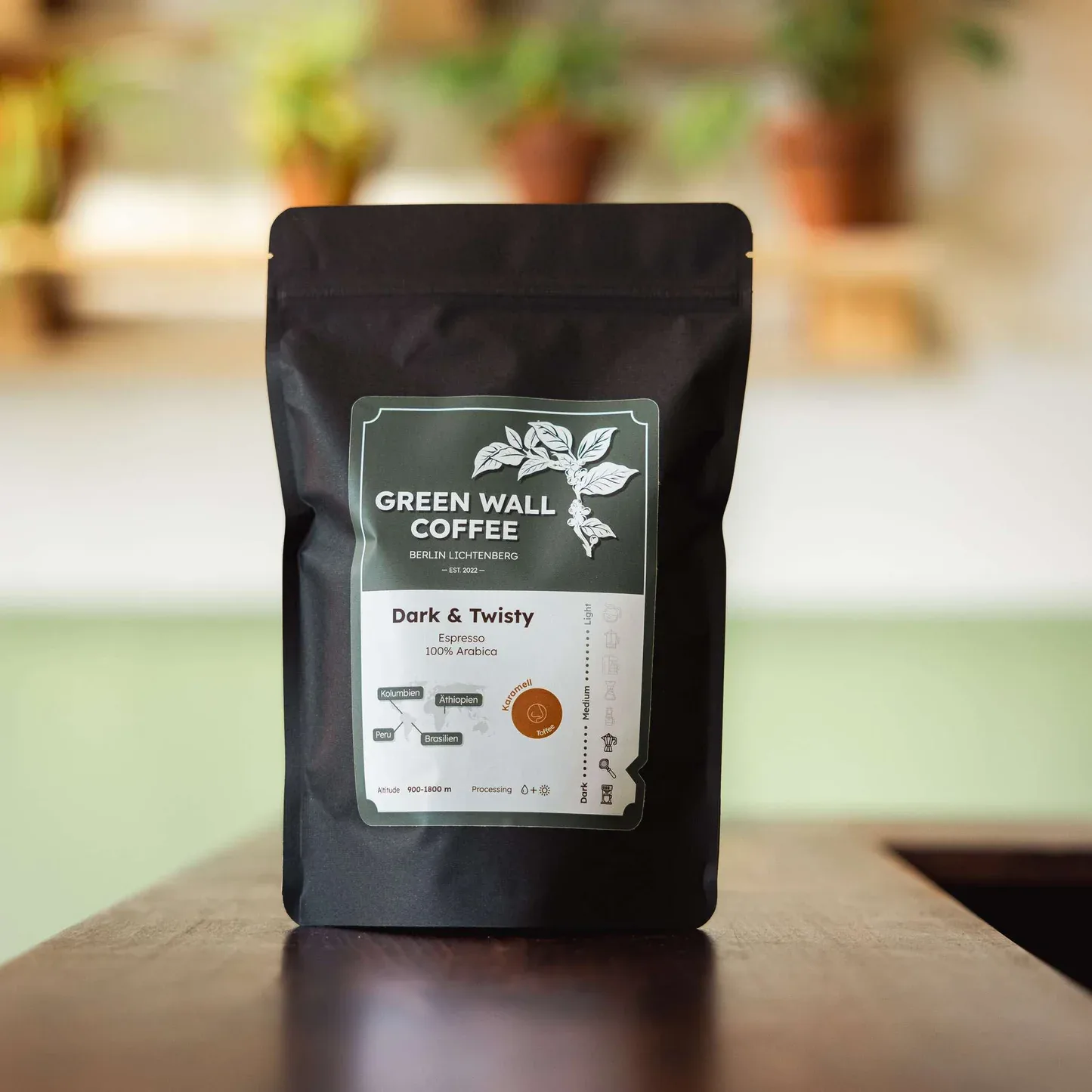 black coffee bag with green label displayed on wooden surface indoors., green wall coffee, berlin