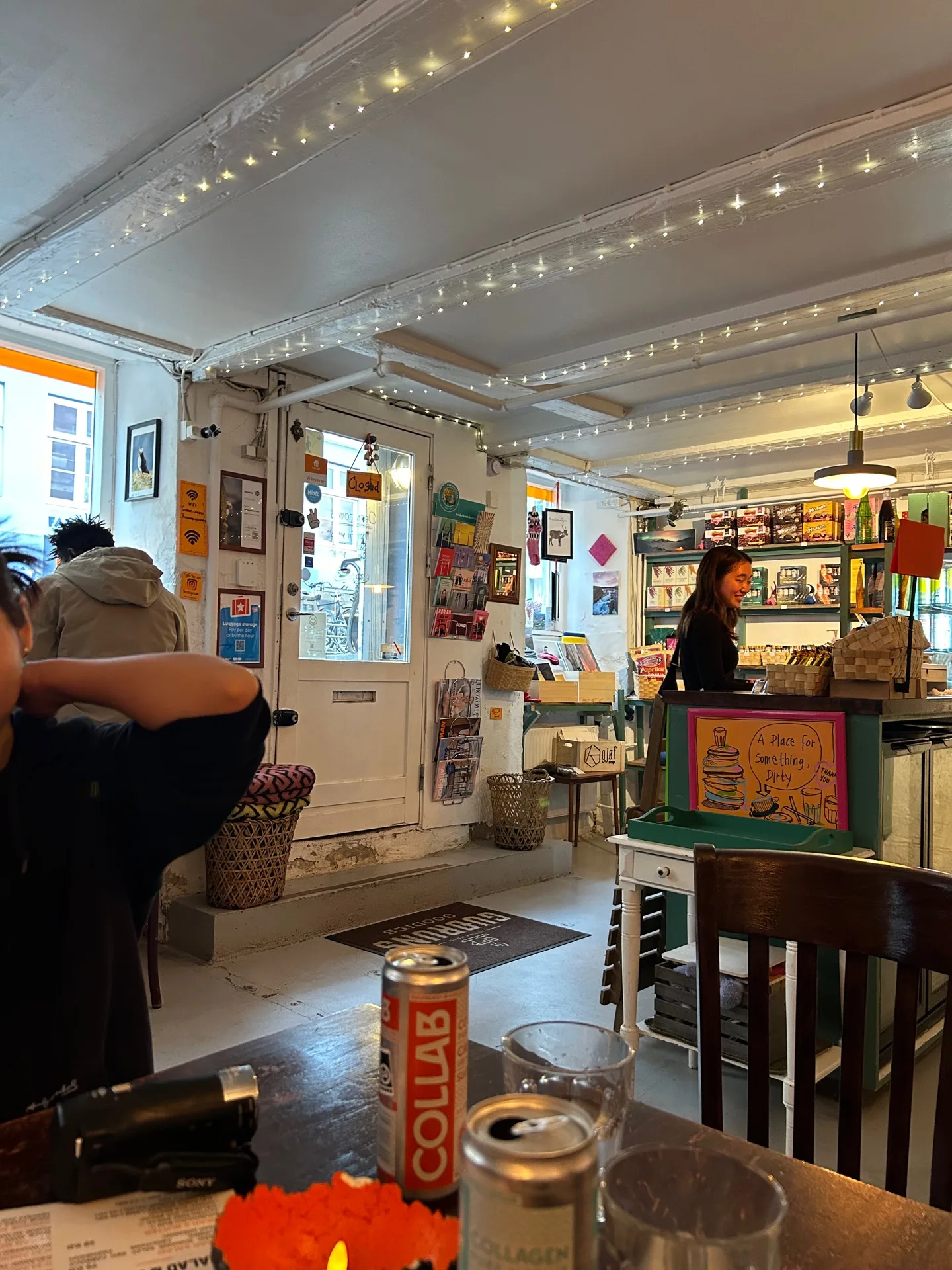 cozy indie bookstore café with warm string lights and eclectic wall decorations., guðrun's goodies - icelandic café - coffee 