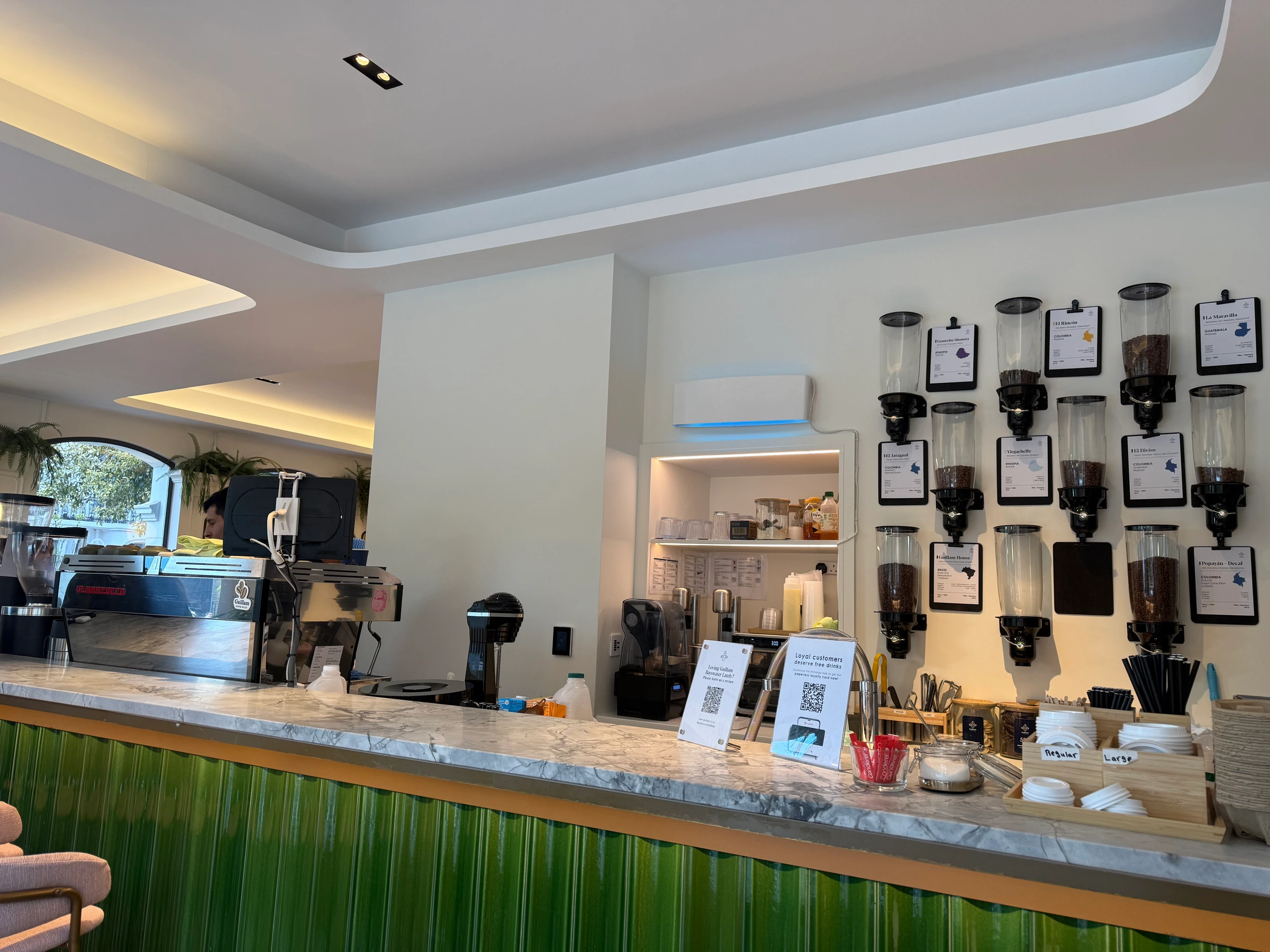interior of guillam coffee house bayswater, banquette seating and the back room laptop set