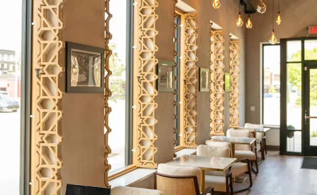modern salon interior with geometric gold trim, waiting chairs, and pendant lighting., haraz coffee house, detroit