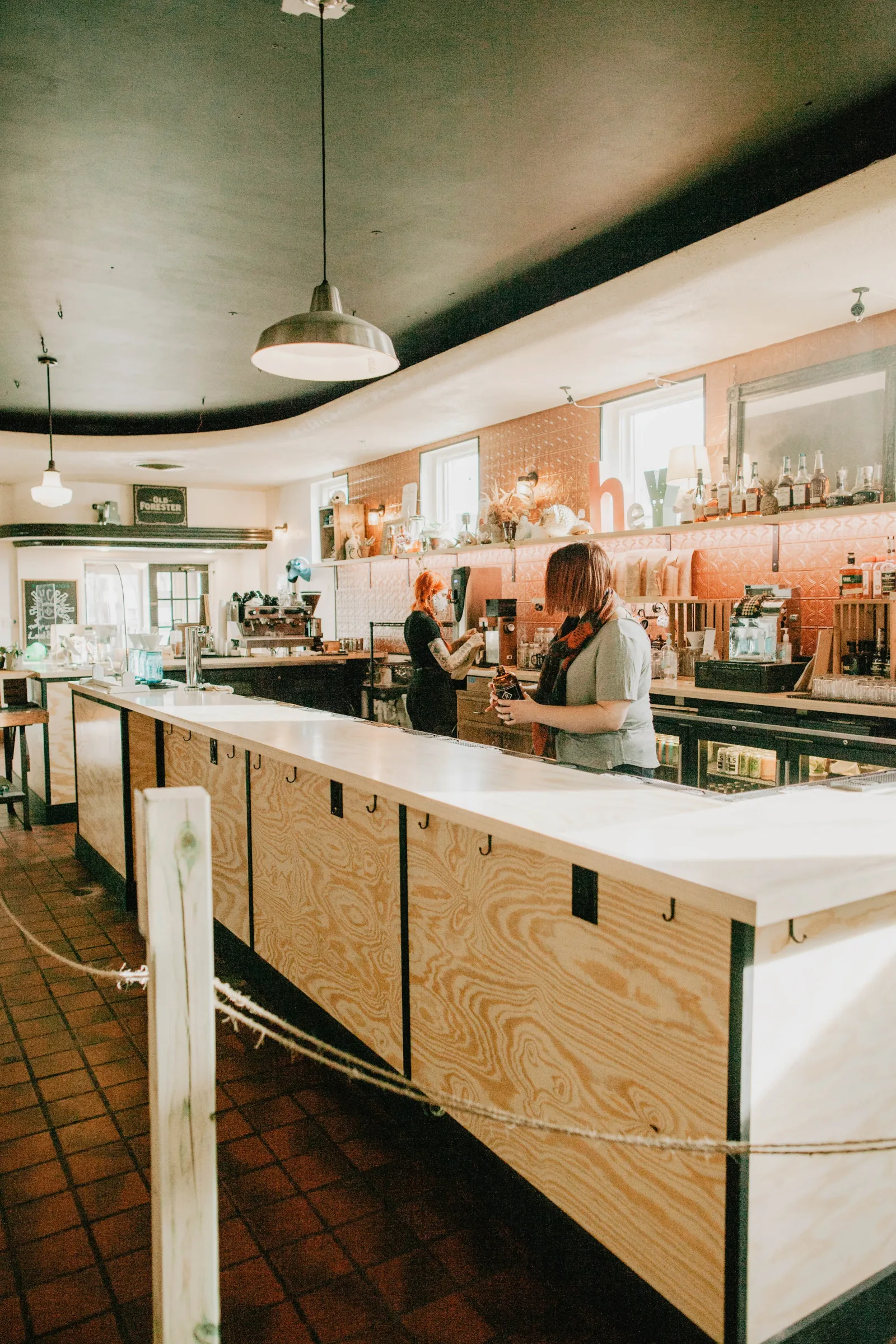 modern café interior with curved ceiling, wooden counter, and staff serving customers., hawthorne coffee roasters, milwaukee