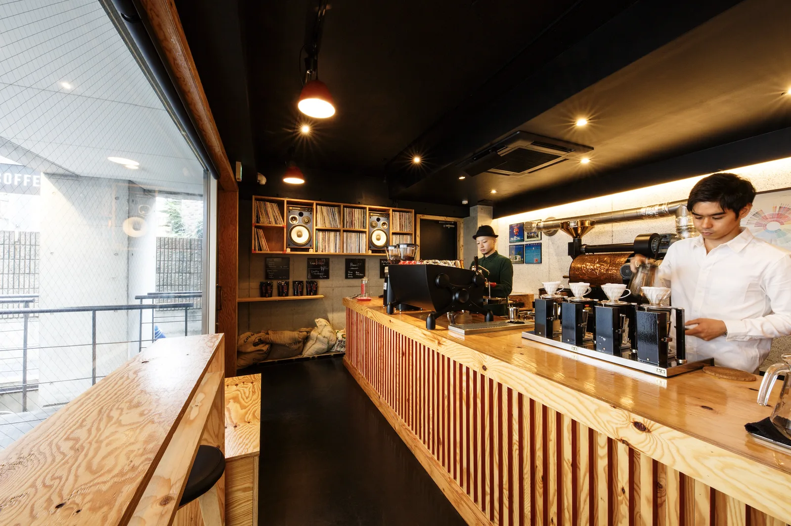 modern coffee shop interior with wooden counter and two baristas preparing drinks., heart's light coffee, tokyo