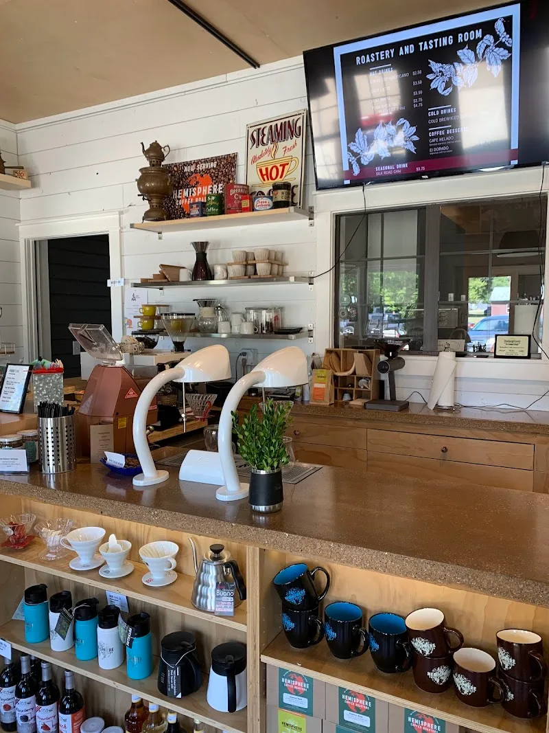 modern coffee roastery counter with merchandise, menu display, and specialty mugs., hemisphere coffee roasters, mechanicsburg