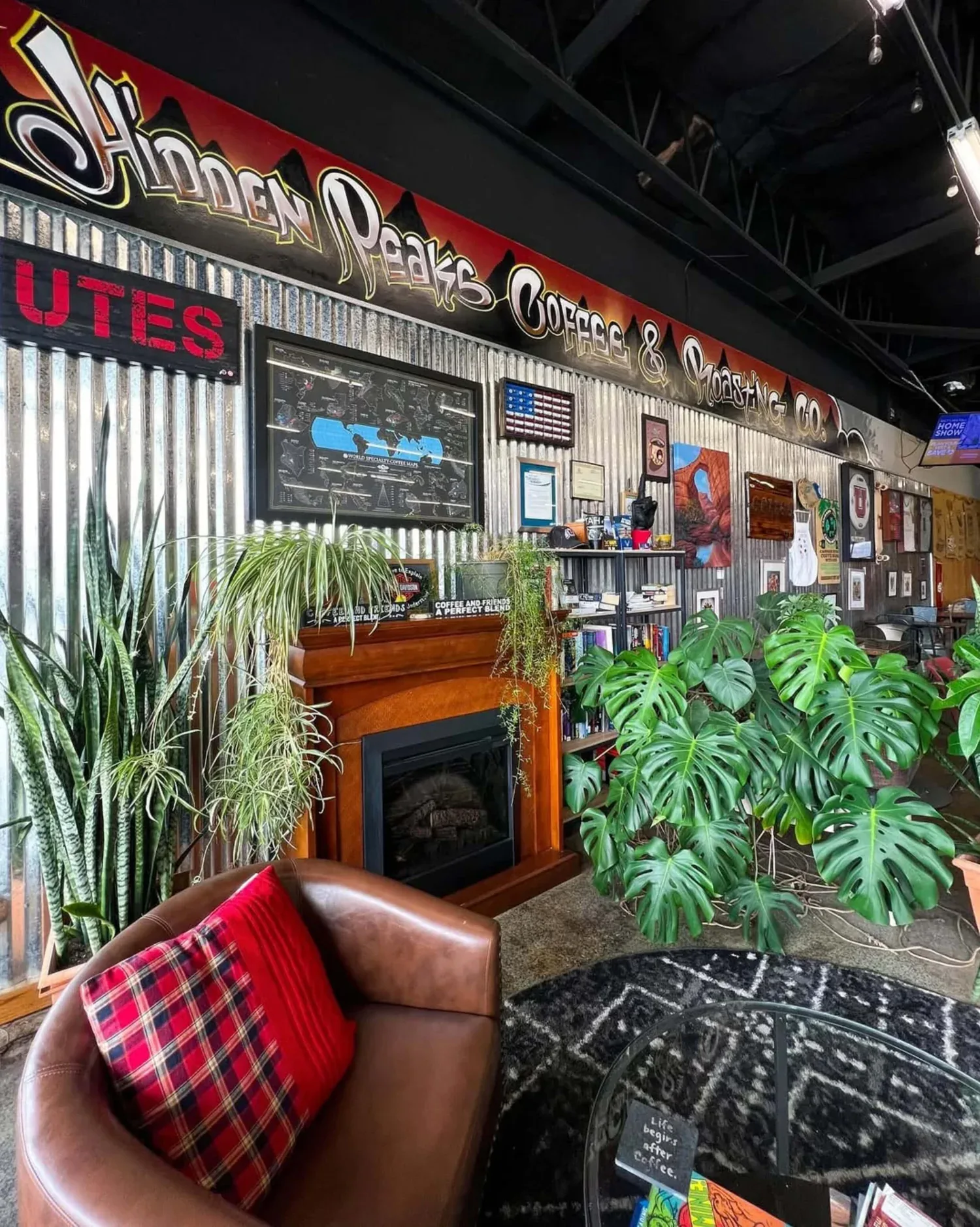 cozy coffee shop interior with fireplace, plants, and rustic decor., hidden peaks coffee and roasting company, salt lake city