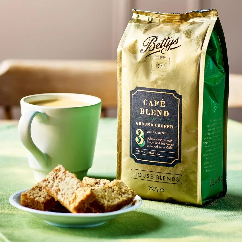 bettys café blend ground coffee package with green mug and cake slices., house of biscuits, curitiba
