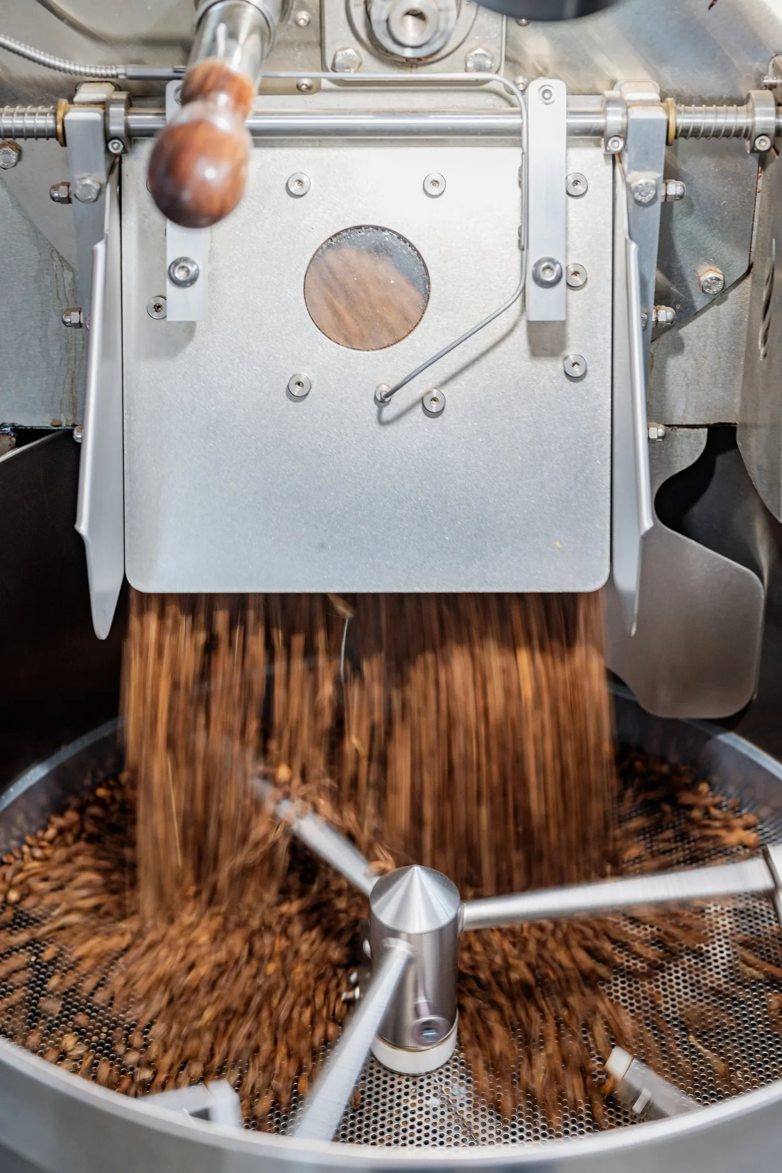 coffee roaster drum with beans cooling on mesh tray below., hydrangea coffee roaster, san francisco