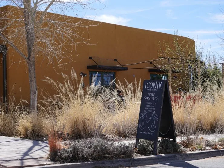 ochre-colored building with "iconik" sandwich shop sign and desert landscaping., iconik coffee roasters, santa fe