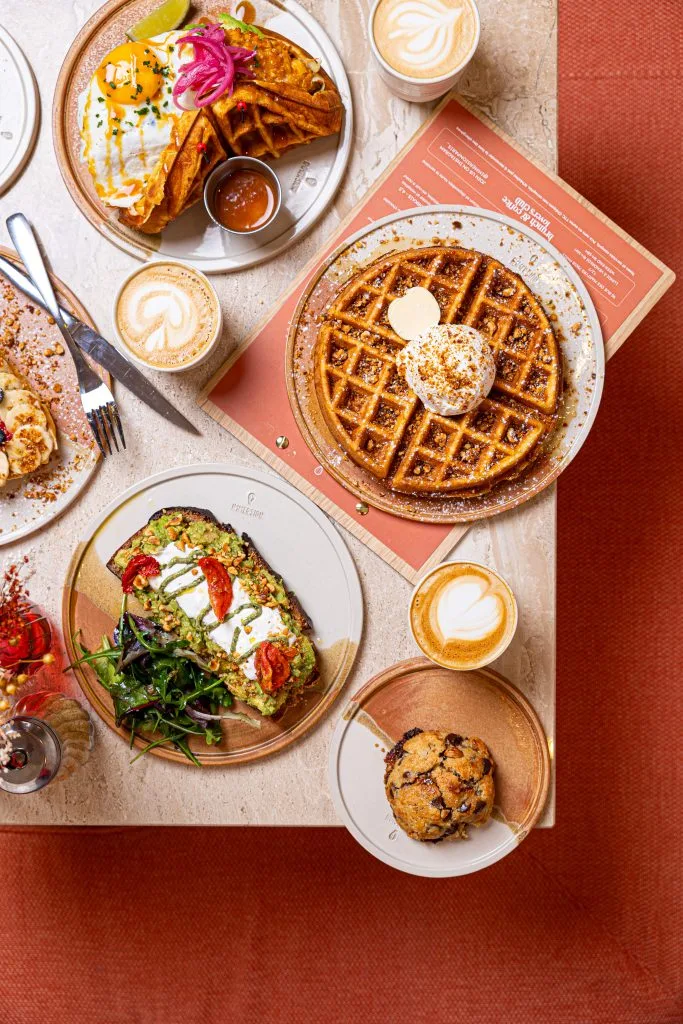 brunch spread with waffles, avocado toast, pastries, and specialty coffee drinks., immersion montmartre - brunch & coffee, pa