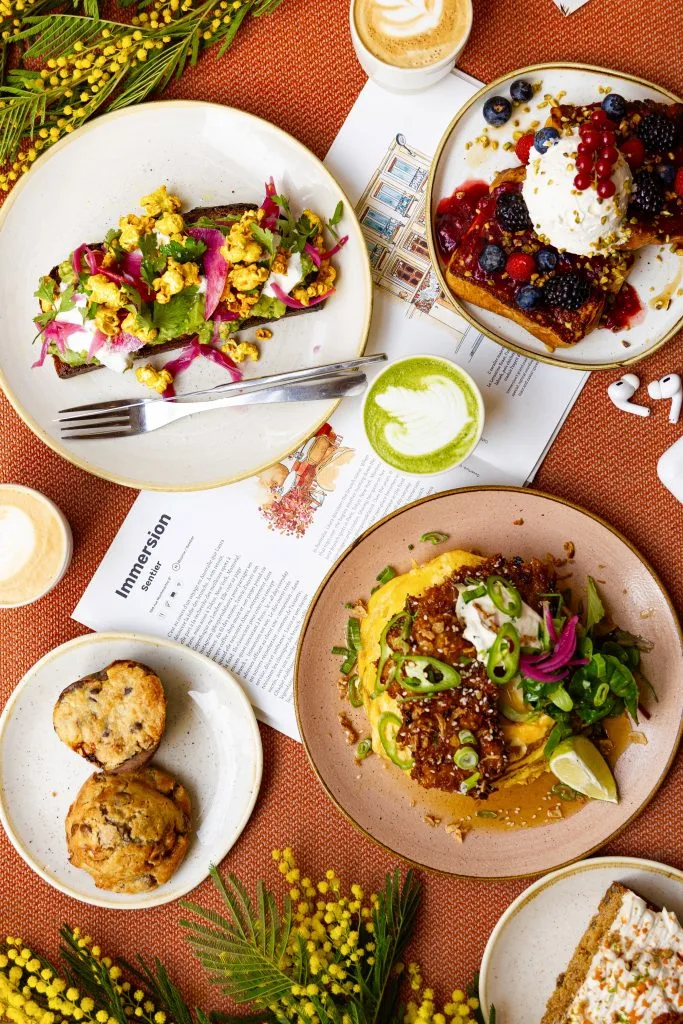 colorful brunch spread with avocado toast, berries, coffee drinks, and pastries., immersion montmartre - brunch & coffee, par