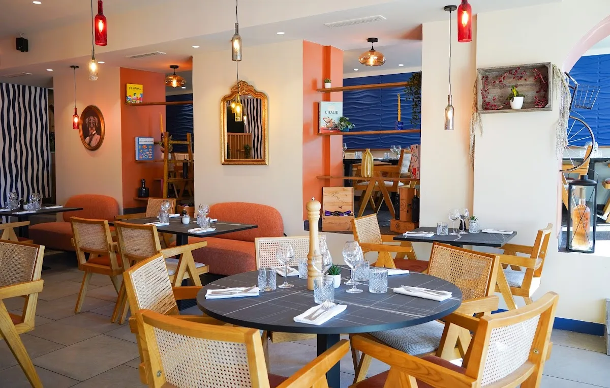 modern restaurant interior with orange walls, wooden chairs, and pendant lighting., impastiamoci, rome