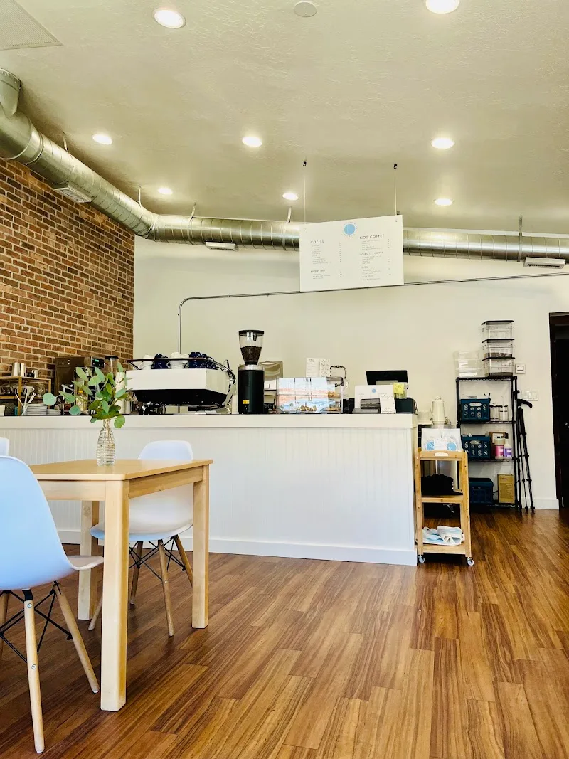 modern café interior with wooden counter, espresso machine, and seating area., incidental coffee roasters, provo
